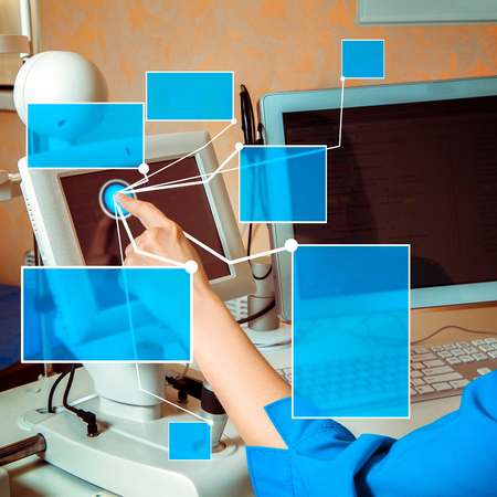 female doctor hand working on touch screen computer in cabinet with virual buttons in the air.