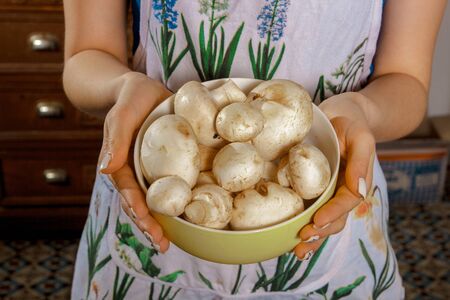 girl holding a plate of mushroomsの写真素材