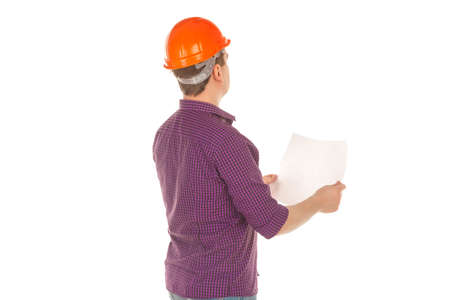 portrait of builder in helmet with plan in hands looking away isolated on white background