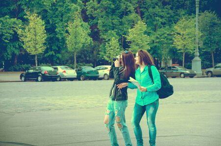 Tourists walk through an unfamiliar city with a backpack and mapの写真素材