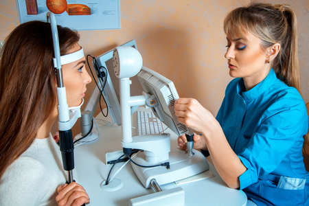 patient checks her vision by an ophthalmologist. Ophthalmologist. medical, health, ophthalmology conceptの写真素材