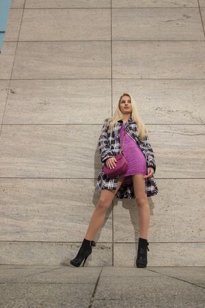 View from down of blonde girl in the cityの写真素材