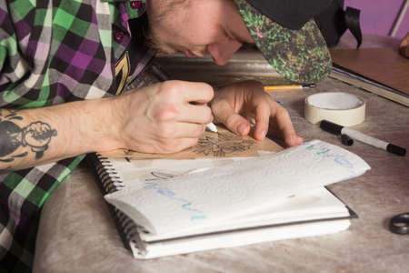 Tatooer is making a mockup of a roseの写真素材