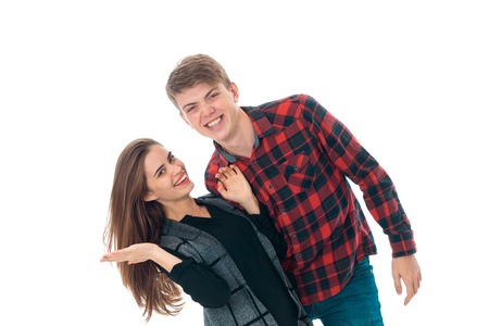 portrait of attractive young stylish couple in love having fun in studio isolated on white backgroundの写真素材