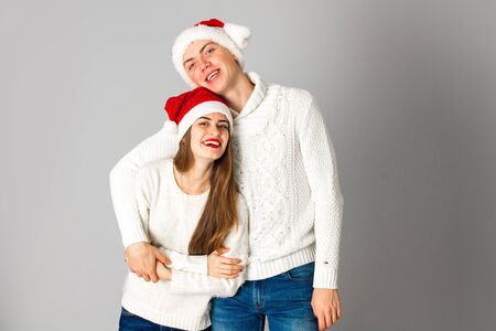 happy couple celebrate christmas in studio on grey backgroundの写真素材