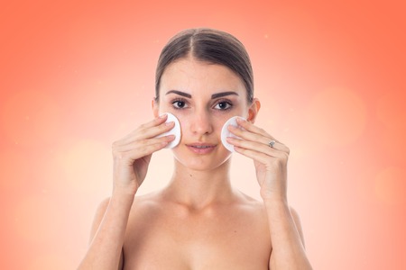 gorgeous girl takes care her skin with Cleansing cotton pad isolated on white background. Health care concept. Body care concept. Young woman with healthy skin.の写真素材