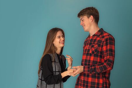 stylish couple in love having fun in studio on blue backgroundの写真素材
