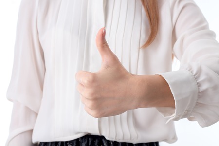 girl in white shirt stretched hand and shows gesture classの写真素材