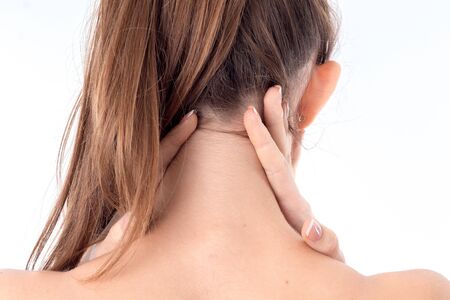 girl worth backwards and keeps hands behind the neck is isolated on a white backgroundの写真素材