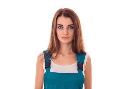 young charming builder girl in uniform makes renovation isolated on whiteの写真素材