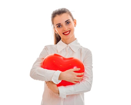 portrait of happy brunette in love with red heart isolated on white . saint valentines concept. love concept.の写真素材