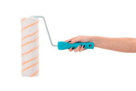 close up of female hand holding a painting outrigger isolated on whiteの写真素材