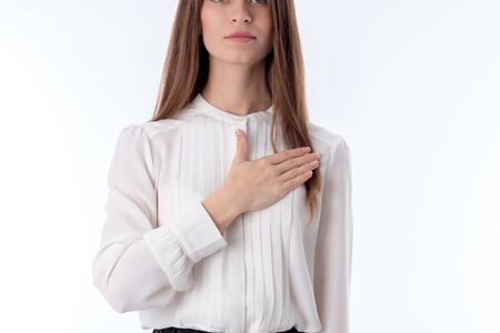 girl in the white blouse put her hand on his chest, close-upの写真素材