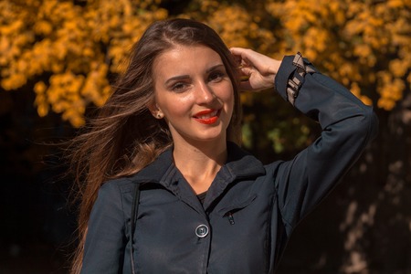 young girl with red lipstick on lips and black shirt in the Parkの写真素材
