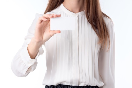 girl in white shirt stands up straight and keeps itself the paper leafの写真素材
