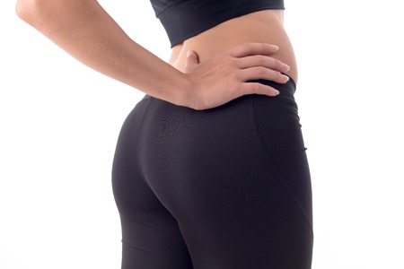 booty young sports girls in black trousers close-up in studio