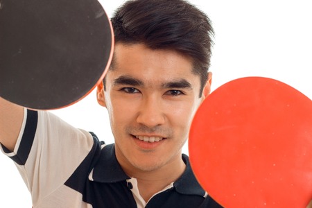 handsome brunette sports man practicing ping-ping isolated on whiteの写真素材
