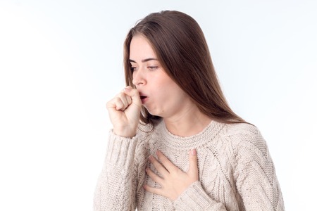 woman fell ill and coughing isolated on white backgroundの写真素材