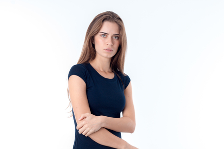 the girl in the black shirt keeps hand elbow isolated on whiteの写真素材