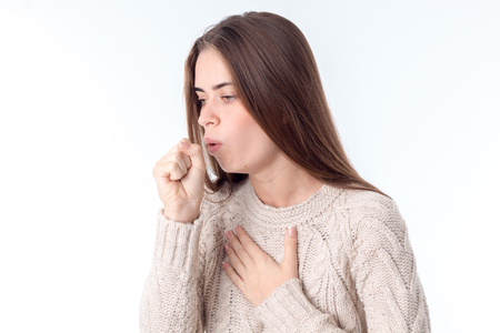 beautiful girl fell ill and coughing isolated on white backgroundの写真素材