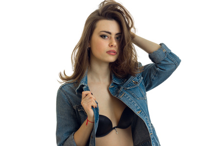 sexy young brunette standing in Bra and jacket and keeps hand hair close-up isolated on white backgroundの写真素材