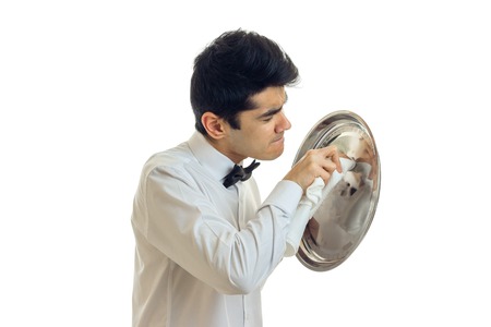 young handsome waiter in a white shirt side towel tray for Cookware is isolated on a white...
