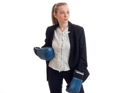 young blonde in ofissnom costume and boxing gloves looks toward isolated on white backgroundの写真素材