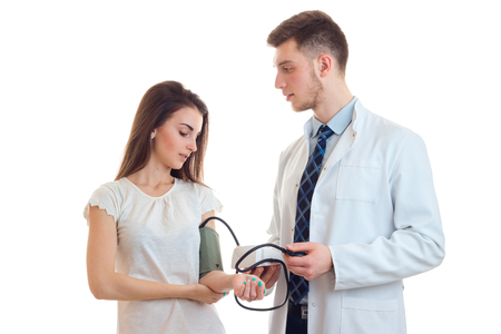 a young girl came to the doctor to measure pressure isolated on white backgroundの写真素材