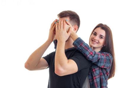 beautiful smiling girl closes her eyes hands a young boy isolated on white backgroundの写真素材