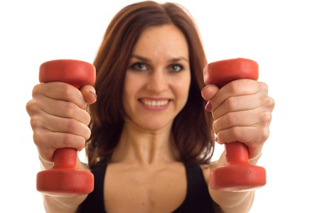 Portrait of beautiful sports girls that stretched forward dumbbells in hands close-up isolated on...