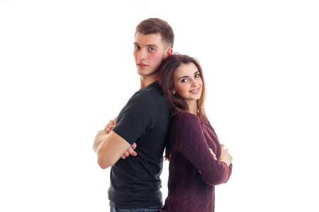 smiling pin-up girl is standing next to a high cute guy back to back is isolated on a white backgroundの写真素材