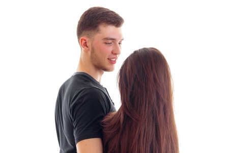 girl with long hair cute smiling stands opposite guy close-up isolated on white background