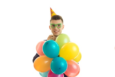 funny great young kid keeps ourselves lots of colored balls is isolated on a white backgroundの写真素材