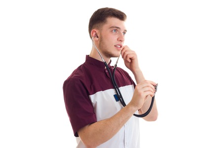 young doctor examines the stethoscope in your ears is isolated on a white background close-upの写真素材