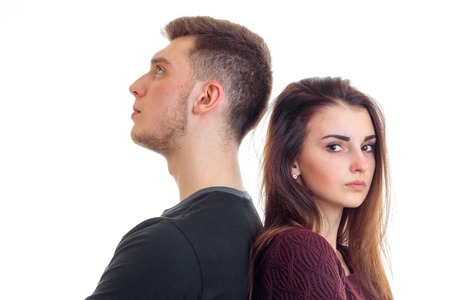 Portrait of serious young couple in studio isolated on white backgroundの写真素材
