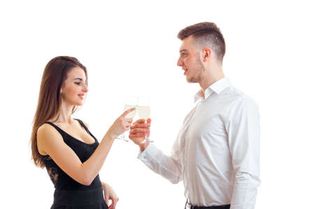 beautiful elegant couple drinking champagne isolated on white backgroundの写真素材