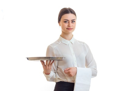 beautiful woman waiter with a tray in hands isolated on white backgroundの写真素材