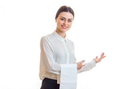 Cheerful waitress smiles on camera in uniform isolated on white backgroundの写真素材