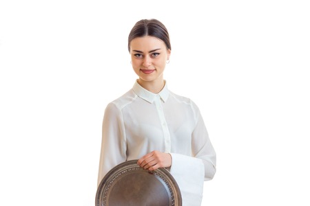 beautiful woman waitress in uniform with trey in hands isolated on white backgroundの写真素材