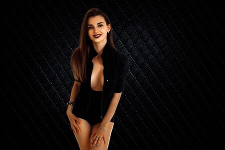 Sexual young brunette girl with big breast in studio on black backgroundの写真素材