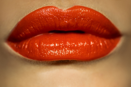 macro picture of female lips with red lipstick in studioの写真素材
