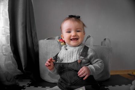 Cutie little baby girl smiles on camera at home