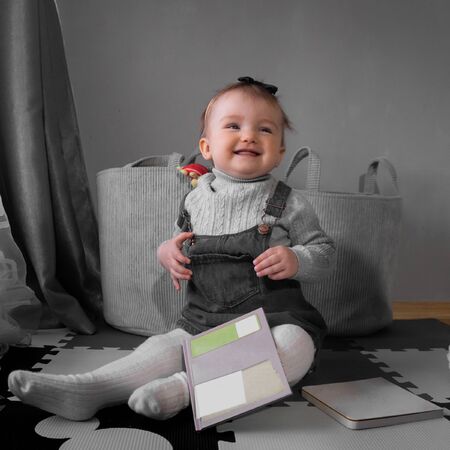 square picture of Cute little baby girl smiles at home