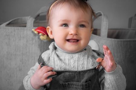 happy little baby girl smiles at home