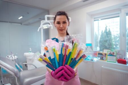 set of toothbrushes in the hands of the dentist at the clinicの写真素材