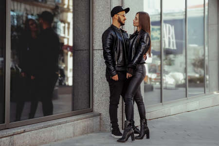 beautiful couple walks across the road in the streetの写真素材
