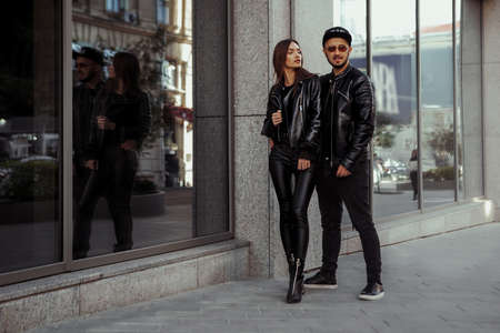beautiful couple walks across the road in the streetの写真素材