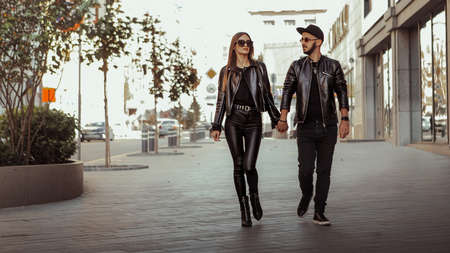 beautiful couple walks across the road in the streetの写真素材
