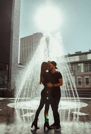 beautiful couple walks across the road in the streetの写真素材