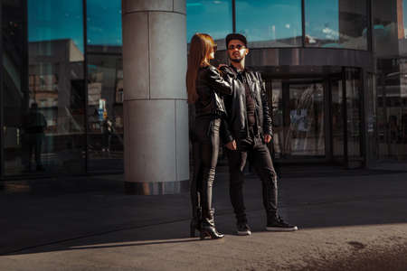 beautiful couple walks across the road in the streetの写真素材